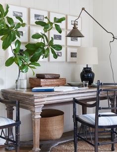 an image of a table and chairs in a room with pictures on the wall behind it