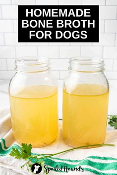 two jars filled with homemade bone broth for dogs sitting on a towel next to each other