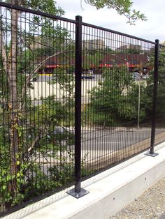 a black metal fence next to a road