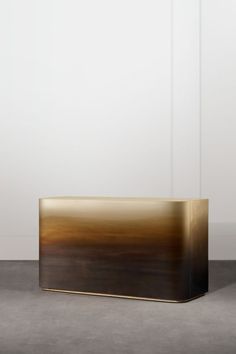 a large metal box sitting on top of a cement floor next to a white wall