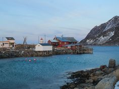 a body of water surrounded by mountains and houses