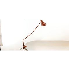 a desk lamp sitting on top of a white table