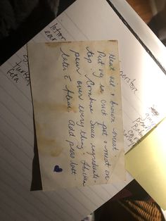 an old piece of paper that has been left on top of some papers with writing