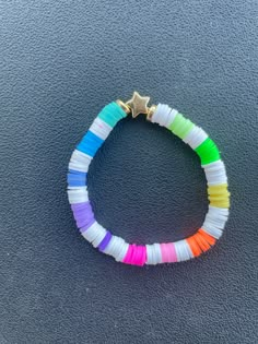 a colorful bracelet with a gold star on it