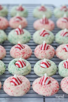 christmas sprinkle cookies on a cooling rack with candy canes in the middle