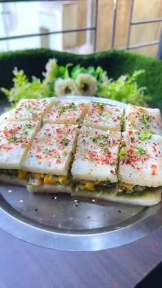 there is a plate that has some food on it and two plants in the background