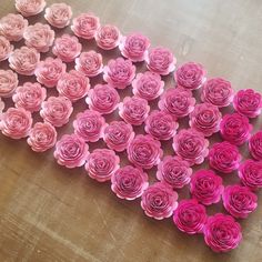 pink paper flowers arranged in the shape of a heart