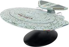 the star trek enterprise model is on display in front of a white background and black base