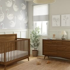 a baby's room with a crib and dresser