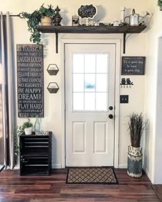 the front door is decorated with plants and other things on shelves above it, along with an entry mat