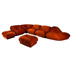 an orange couch and ottoman on a white background