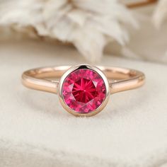 Experience timeless beauty with our Round Cut Bezel Lab Grown Ruby Ring in 14K rose gold, a perfect choice for solitaire, bridal, and anniversary gifts. 14k Rose Gold Solitaire Ring, Rose Gold Solitaire Ring, Gold Solitaire Ring, Aquamarine Rings, Luxury Gift Box, July Birthstone, Affordable Jewelry, Ruby Ring, Lab Diamonds