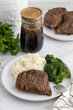 steak, mashed potatoes and broccoli on a plate with a jar of sauce