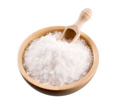 a wooden bowl filled with white sugar