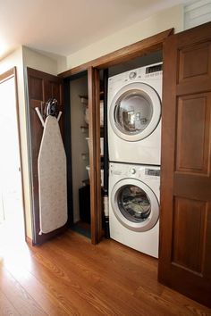 a washer and dryer sitting in a room next to an open closet door