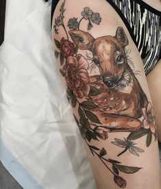 a woman with a deer tattoo on her arm