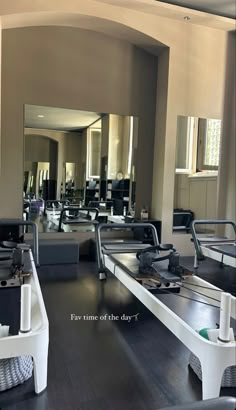 an empty room with mirrors on the wall and tables in front of it that have been set up for salons