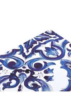 a blue and white table cloth with swirls on it's edges, against a white background