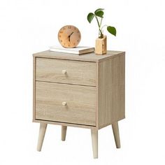 a small wooden nightstand with a clock and plant on it's side table, against a white background