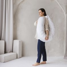 a pregnant woman standing in front of a window