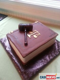 a cake with a judge's book on top of it and a wooden gaven