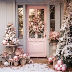 pink and white christmas decorations in front of a door with wreaths on the side