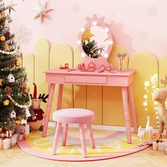 a pink desk with a mirror and stool next to a christmas tree