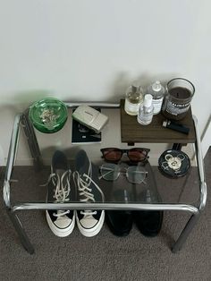 there is a glass table with some shoes on it