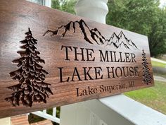 a wooden sign that says the miller lake house