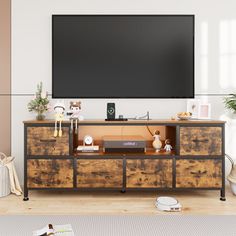 a flat screen tv mounted to the side of a wooden cabinet in a living room