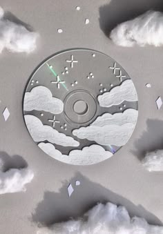 a cd cover with clouds and stars in the sky as if it were made out of paper