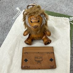 Lion Keychain And Card Holder In Cognac Visetto Mcm Card Holder, Brown Card Holder With Key Clip For Daily Use, Luxury Brown Card Holder With Coin Pocket, Lion Keychain, Brown Vintage Coin Purse With Interior Card Slots, Key Card Holder, Lion, Card Holder, Women Accessories