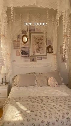 there is a bed with white sheets and decorations on the headboard, along with pictures above it