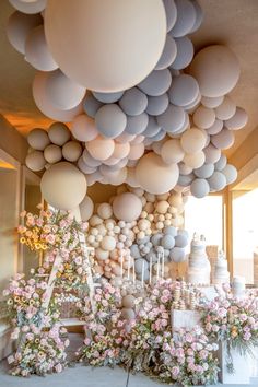 balloons and flowers are hanging from the ceiling