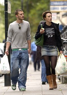 a man and woman walking down the street