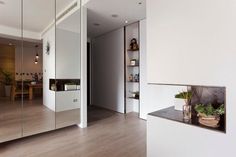 the interior of a house with white walls and wood flooring is decorated in modern style