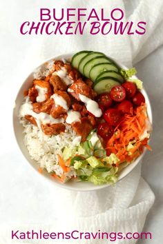 a white bowl filled with rice, cucumber and chicken bowls on top of a towel