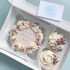 three cupcakes with frosting in a box