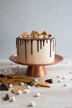 a cake with marshmallows and chocolate drizzled on the top