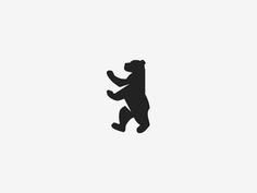 the silhouette of a bear is shown in black on a white background, and it appears to be jumping