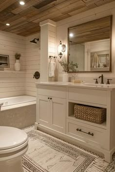 a bathroom with a toilet, sink and bathtub next to a mirror on the wall