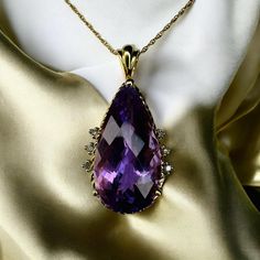 SAME DAY SHIPPING! This is a gorgeous solid 10k Yellow Gold necklace with a mesmerizing LARGE 7 Carat Pear Cut Faceted Natural Amethyst gemstone and diamond accents in a prong setting. The solid 10k yellow gold chain is approximately 20 inches long, pendant approximately 28.5mmx15mm. Excellent anniversary gift for wife, girlfriend, february birthstone birthday gift for daughter, etc.!  Mothers Day Gift or Christmas Gift! We also sell 10k, 18k, and 14k jewelry, engagement rings, wedding rings, promise rings, Christmas gifts, April birthstone rings, birthday gifts, Valentine's Day gifts, fall fashion jewelry, diamond rings, sapphire jewelry, ruby & emerald pendants, necklaces, bracelet, earrings, chain, luxury jewelry, &waterfall rings.Color may vary due to monitor settings. Everything we se Emerald Pendants, Gift For Wife Birthday, April Birthstone Ring, Birthday Gift For Daughter, Jewelry Ruby, Rings Sapphire, Rings Promise, Earrings Chain, Birthstone Rings