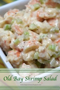 an old bay shrimp salad in a white serving dish on a green and yellow striped tablecloth