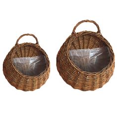 two brown wicker baskets with clear plastic bags in the bottom one is empty and the other has a bag inside it