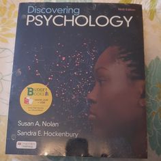 a book on the cover of discovering psychology with an image of a woman's face