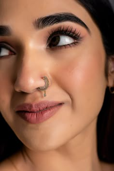 This diamond nath (nose ring) for women with pierced nostrils is an easy to wear item that goes safely through your piercing and clicks into the lock to form a comfortable sitting on your nose. It has an elusive traditional feel about it and is great for any big traditional occasion like weddings, sangeet, religious & spiritual gatherings. Give it a go if you are someone with a flair for big statement pieces. This jewelry comes with a diamond certificate from Solitaire Gemological Lab & a pretty Nose Rings For Women, Big Nose Rings, Nose Ring For Big Nose, Hairstyles For Big Faces For Women, Nose Ring Aesthetic Indian, Nose Ring On Big Nose, Gold Nose Ring Indian Brides, Diamond Nose Ring Hoop, Nath Nose Ring Gold