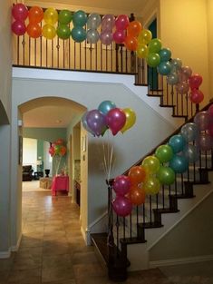 balloons are floating down the stairs in this house