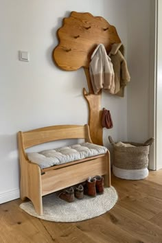 a wooden bench sitting next to a coat rack