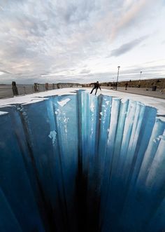 a man standing on top of a large blue object