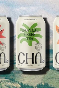 three cans of tropical green tea with mountains in the background